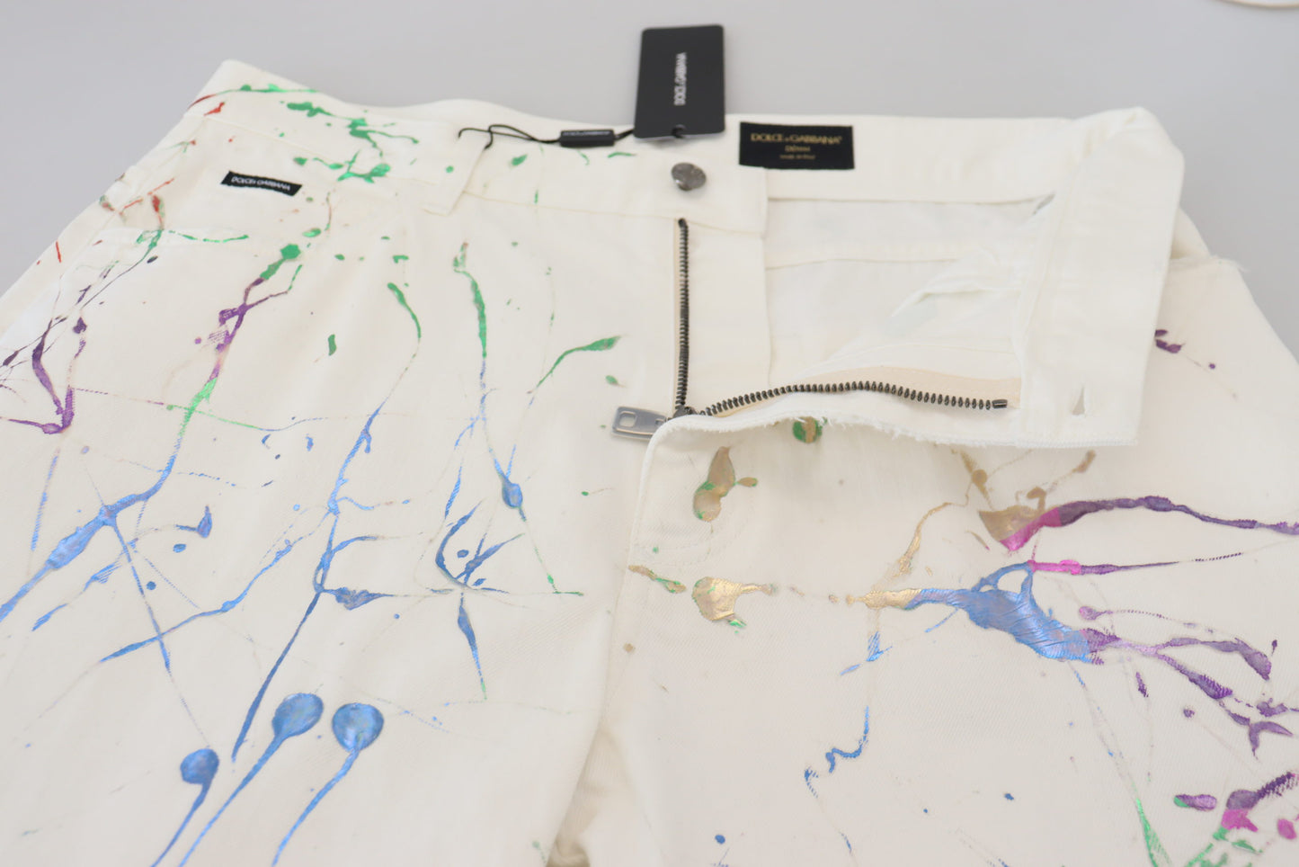 Dolce & Gabbana – Weiße Jeanshose aus Baumwolle mit Farbspritzer-Print