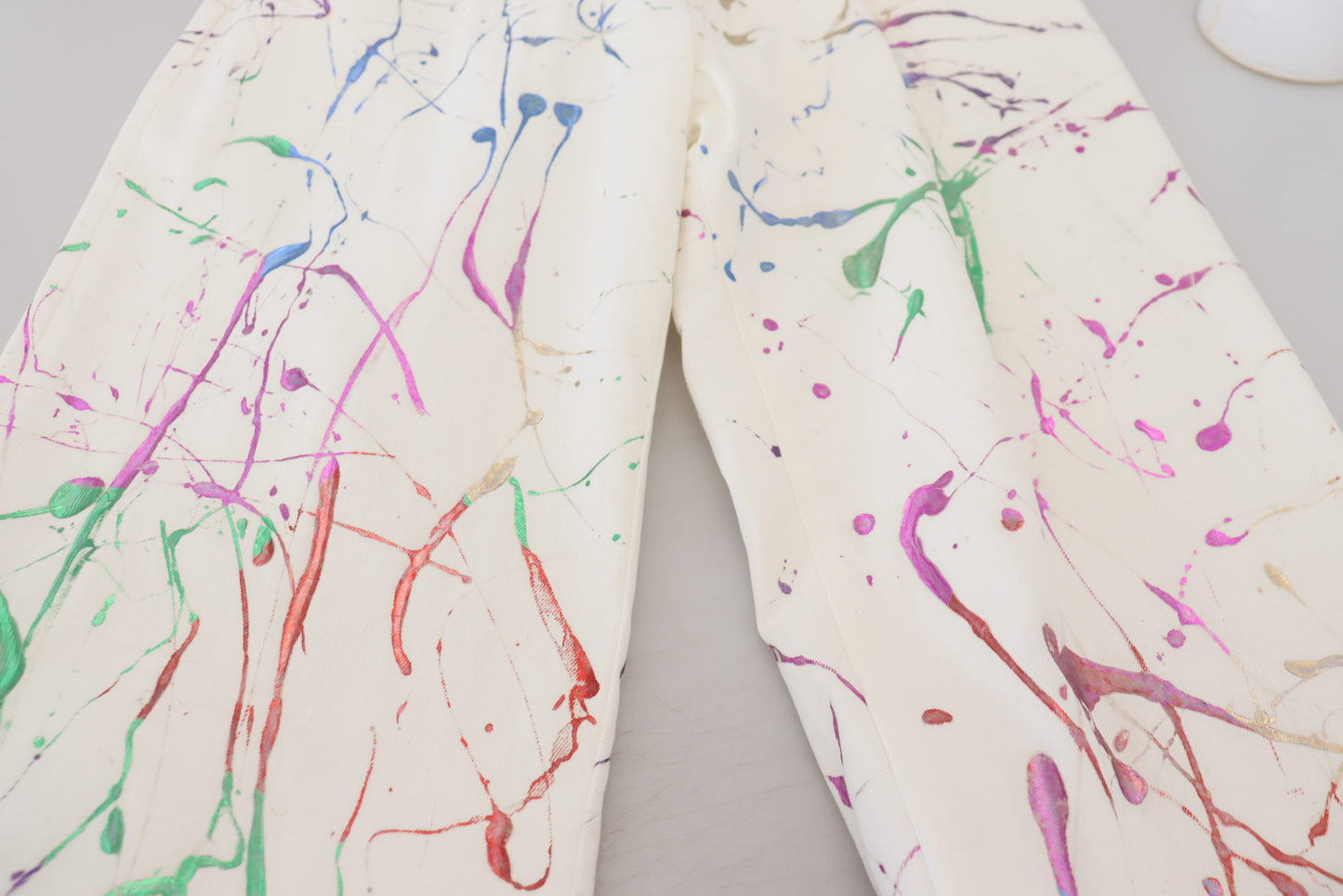Dolce & Gabbana – Weiße Jeanshose aus Baumwolle mit Farbspritzer-Print