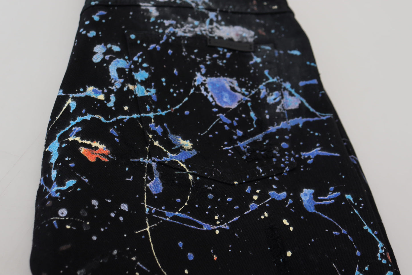 Dolce & Gabbana – Schwarze Jeans aus Baumwoll-Denim mit Farbspritzer-Print