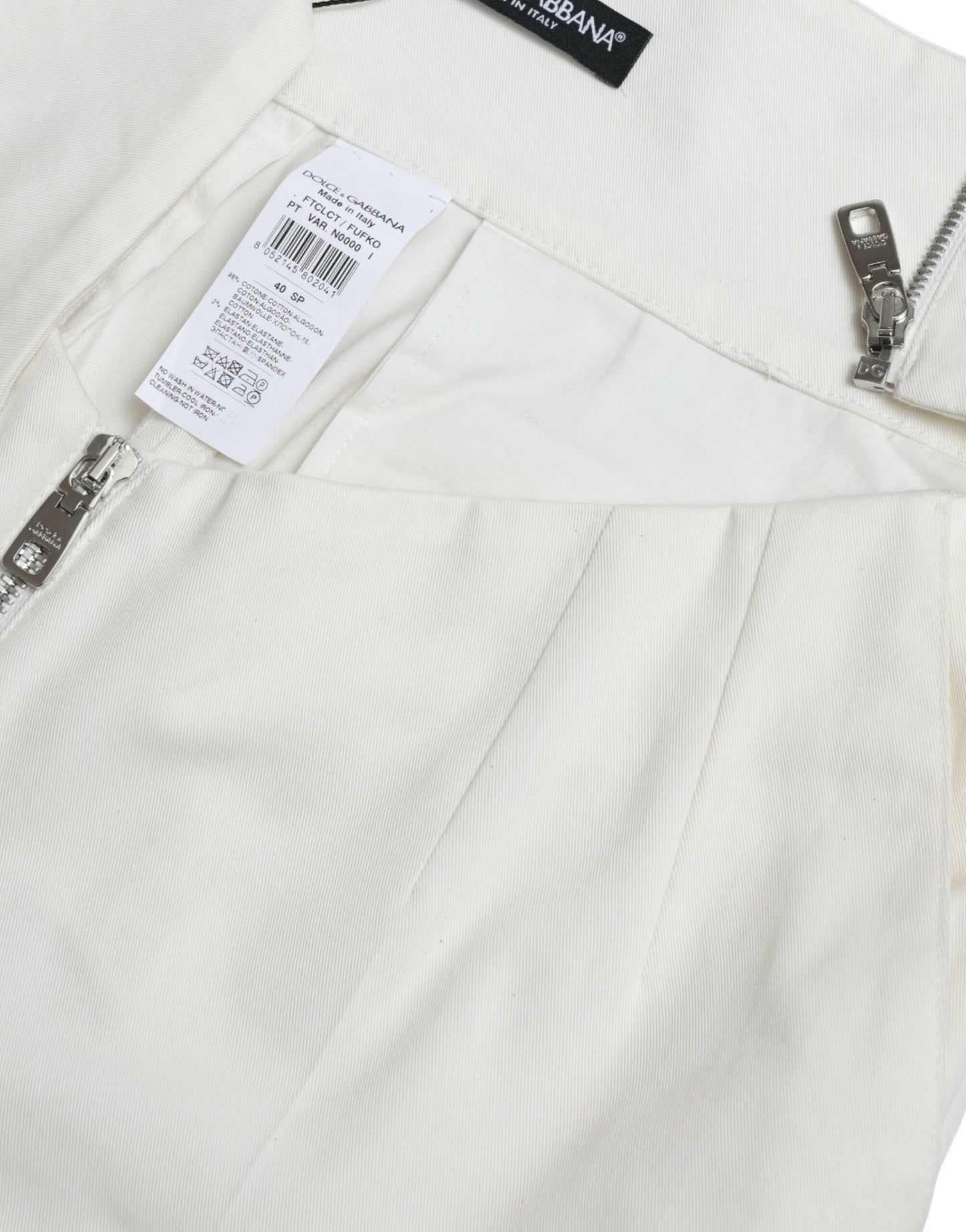 Dolce & Gabbana – Schmal zulaufende Hose aus Baumwolle in Schwarz und Weiß mit Cut-Out-Taille